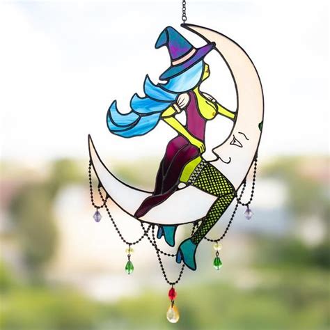 Symbolizing Feminine Power: Witch Riding Moon in Stained Glass